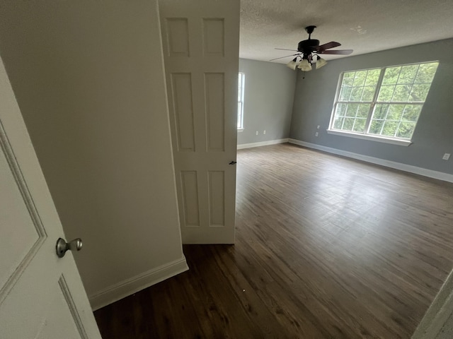 4932 Joiner Cir, Milton, FL 32583 - spare room featuring dark wood-style flooring, baseboards, ceiling fan, and a textured ceiling