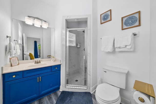 512 Dement Cir Apt F, Panama City Beach, FL 32407 - full bathroom featuring toilet, a stall shower, vanity, and wood finished floors