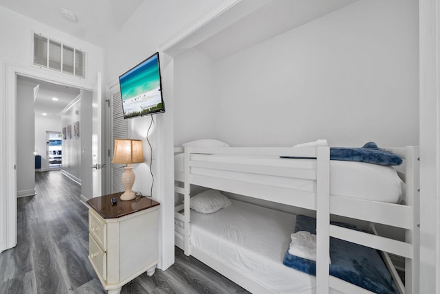 512 Dement Cir Apt F, Panama City Beach, FL 32407 - bedroom featuring dark wood finished floors and baseboards