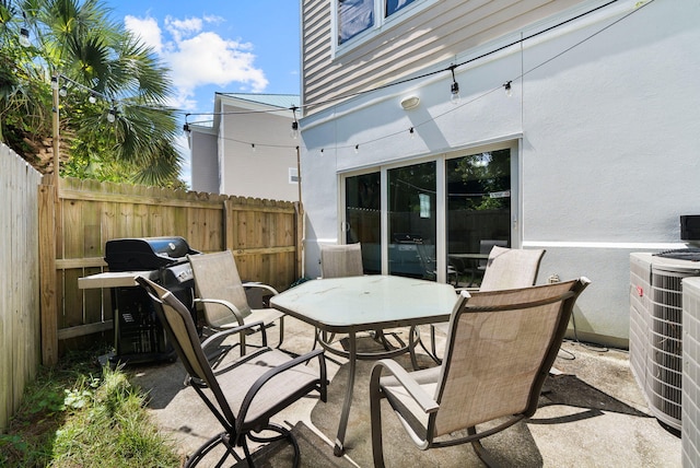 512 Dement Cir Apt F, Panama City Beach, FL 32407 - view of patio featuring central AC unit and outdoor dining space