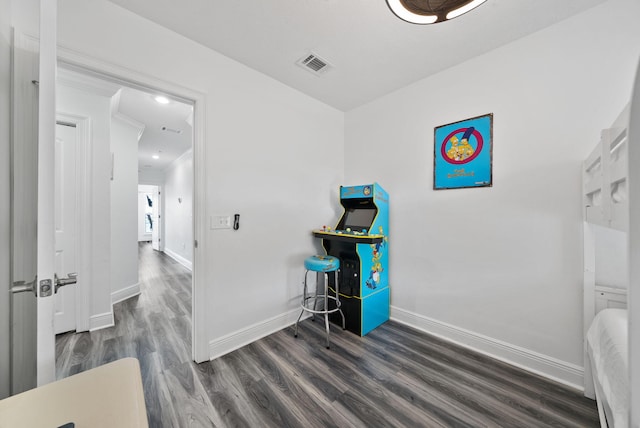 512 Dement Cir Apt F, Panama City Beach, FL 32407 - bedroom with baseboards, dark wood-style floors, and crown molding