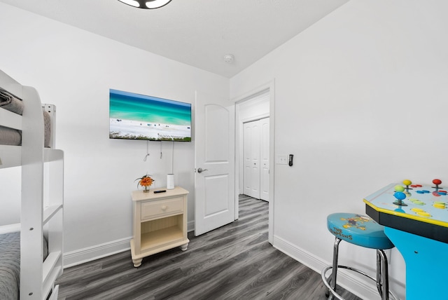 512 Dement Cir Apt F, Panama City Beach, FL 32407 - bedroom with baseboards and dark wood-style floors
