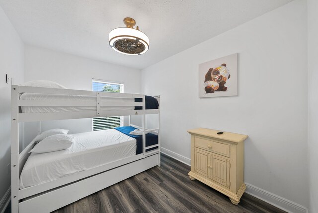512 Dement Cir Apt F, Panama City Beach, FL 32407 - bedroom with baseboards and dark wood-style flooring