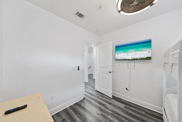 512 Dement Cir Apt F, Panama City Beach, FL 32407 - empty room with baseboards, dark wood-style floors, and a smoke detector