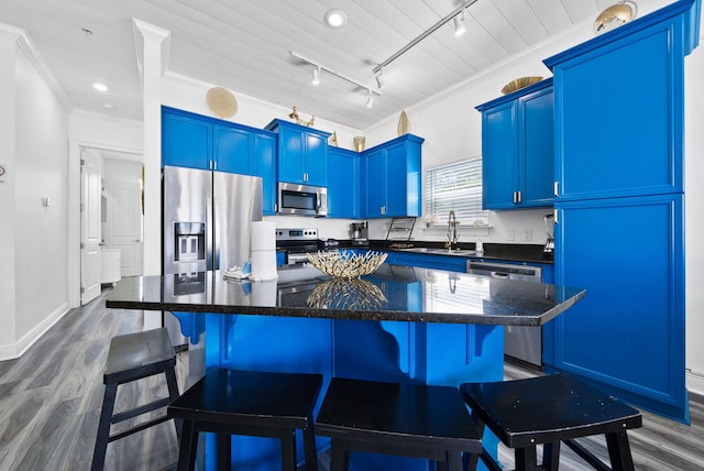 512 Dement Cir Apt F, Panama City Beach, FL 32407 - kitchen featuring stainless steel appliances, blue cabinetry, a sink, dark wood finished floors, and crown molding