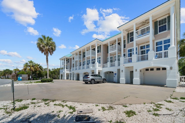 512 Dement Cir Apt F, Panama City Beach, FL 32407 - view of apartment building / complex featuring an attached garage and driveway