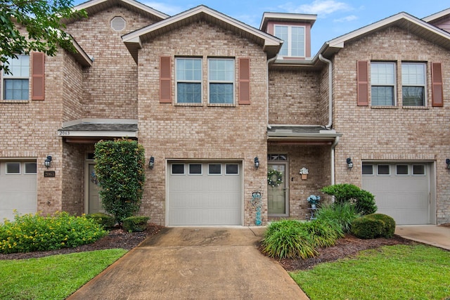 2065 Wilsons Plover Cir, Navarre, FL 32566 - view of front facade featuring concrete driveway, an attached garage, and brick siding