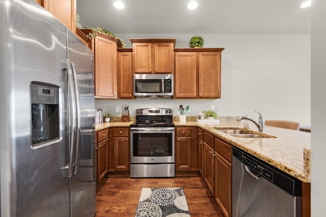 2065 Wilsons Plover Cir, Navarre, FL 32566 - kitchen featuring stainless steel appliances, a sink, dark wood finished floors, light stone counters, and recessed lighting