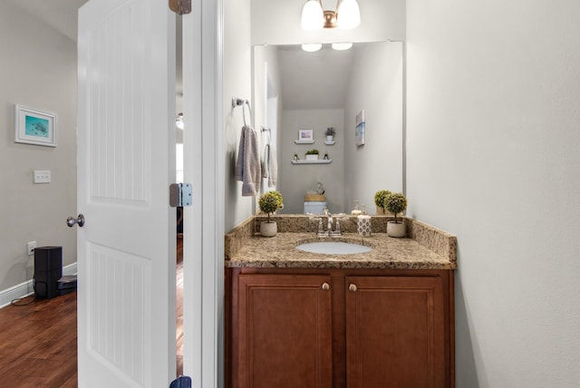 2065 Wilsons Plover Cir, Navarre, FL 32566 - bathroom featuring vanity, wood finished floors, and baseboards