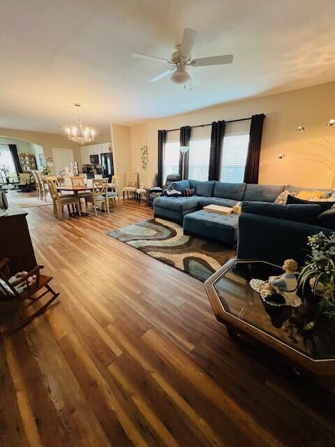 115 Lilly Bell Ln, Freeport, FL 32439 - living room with wood finished floors, healthy amount of natural light, a ceiling fan, and a chandelier
