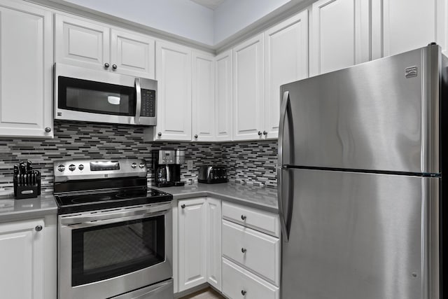515 Topsl Beach Blvd # 401, Miramar Beach, FL 32550 - kitchen featuring stainless steel appliances, white cabinets, tasteful backsplash, and light countertops