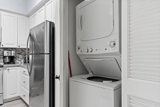 515 Topsl Beach Blvd # 401, Miramar Beach, FL 32550 - washroom featuring estacked washer and dryer and light wood-style flooring