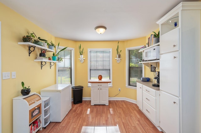 6256 Misty Ln, Crestview, FL 32539 - kitchen with open shelves, light countertops, and white cabinets