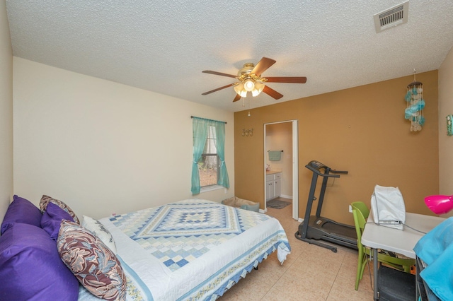 6256 Misty Ln, Crestview, FL 32539 - bedroom with ceiling fan, connected bathroom, and a textured ceiling