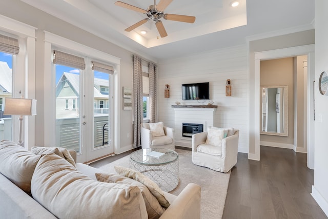 23 E York Ln Unit C, Inlet Beach, FL 32461 - living room with a raised ceiling, dark wood finished floors, a glass covered fireplace, a ceiling fan, and baseboards