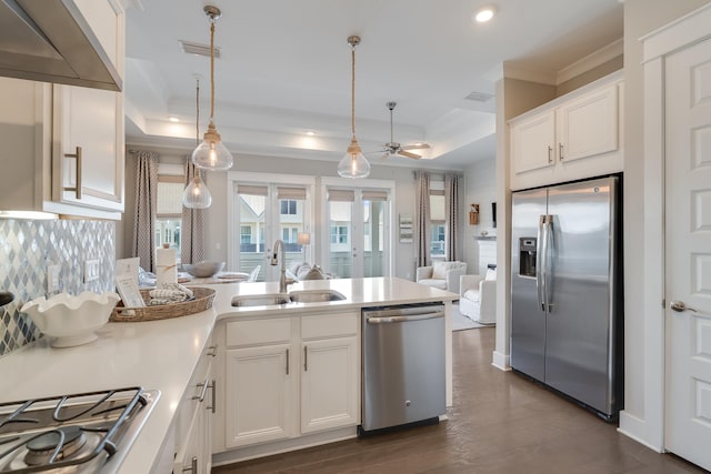 23 E York Ln Unit C, Inlet Beach, FL 32461 - kitchen featuring stainless steel appliances, a sink, ornamental molding, a peninsula, and white cabinetry