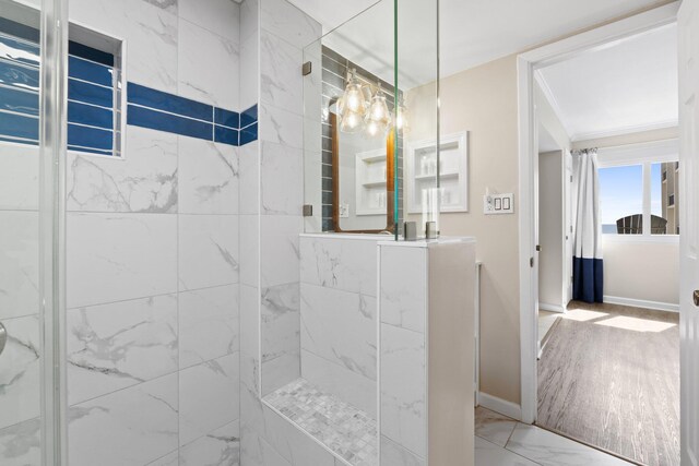 23223 Front Beach Rd # 913, Panama City Beach, FL 32413 - full bathroom featuring marble look tiles, a marble finish shower, vanity, and baseboards