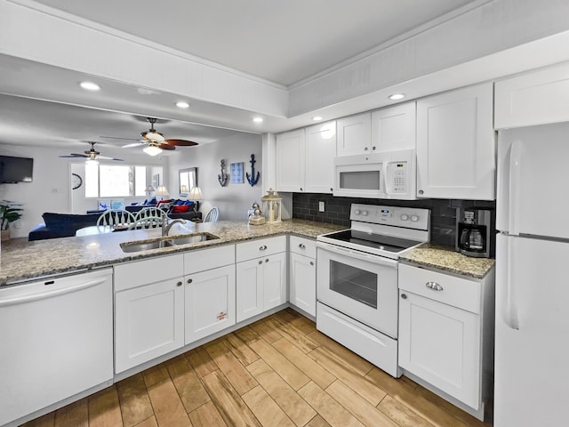 8966 Heron Walk Dr # 8966, Miramar Beach, FL 32550 - kitchen featuring white appliances, a sink, recessed lighting, white cabinetry, and decorative backsplash