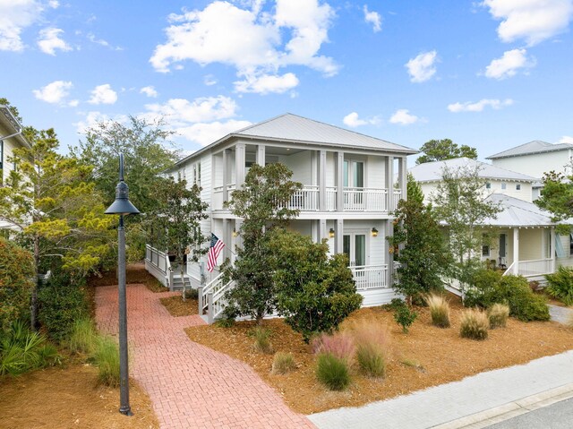 310 Morgans Trl, Santa Rosa Beach, FL 32459 - view of front facade with a balcony, a porch, and decorative driveway