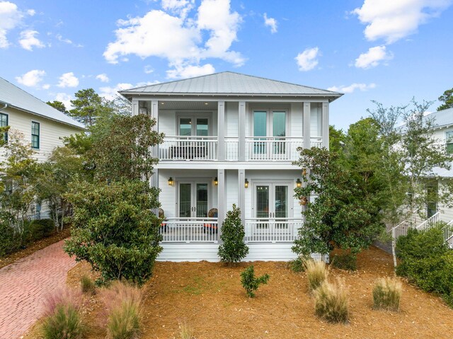 310 Morgans Trl, Santa Rosa Beach, FL 32459 - view of front facade with french doors, a balcony, covered porch, and metal roof