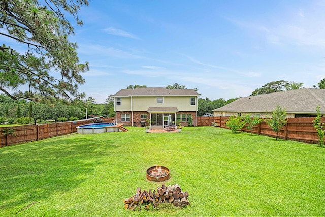 5416 Mill Brook Ln, Crestview, FL 32539 - rear view of property with a fire pit, a sunroom, and brick siding