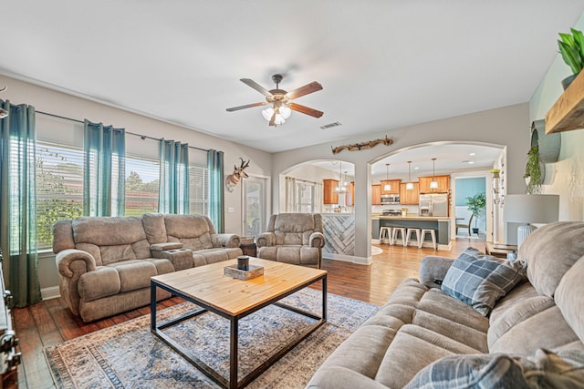 5416 Mill Brook Ln, Crestview, FL 32539 - living room featuring arched walkways, ceiling fan, and light wood finished floors