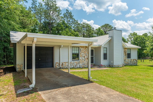5951 N Meadow Ln, Crestview, FL 32539 - view of front of property with stone siding, concrete driveway, a front lawn, a chimney, and a garage