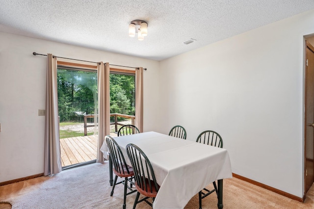 5951 N Meadow Ln, Crestview, FL 32539 - dining space featuring light carpet, baseboards, and a textured ceiling