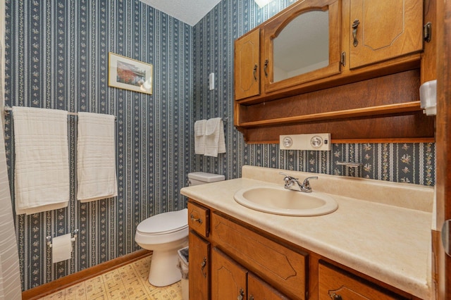 5951 N Meadow Ln, Crestview, FL 32539 - bathroom with wallpapered walls, toilet, and vanity