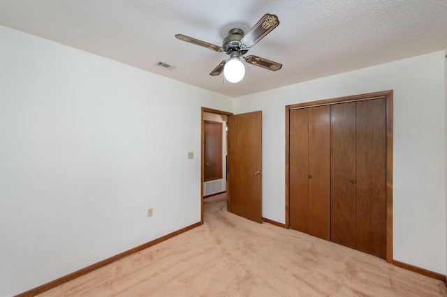 5951 N Meadow Ln, Crestview, FL 32539 - unfurnished bedroom featuring light carpet, a closet, baseboards, a textured ceiling, and ceiling fan