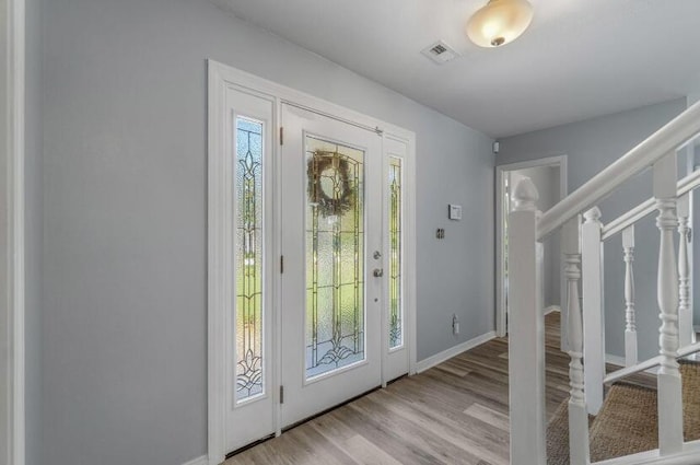 14 Winfield Way, Mary Esther, FL 32569 - foyer entrance with stairway, wood finished floors, and baseboards