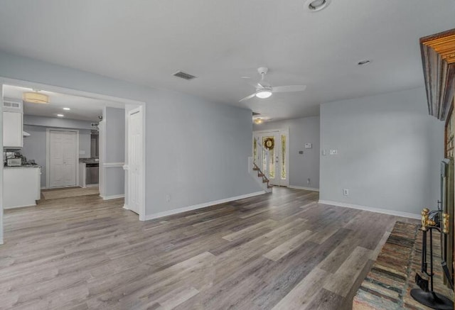 14 Winfield Way, Mary Esther, FL 32569 - unfurnished living room with stairway, a ceiling fan, baseboards, and light wood finished floors
