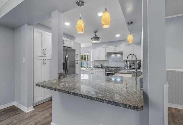 14 Winfield Way, Mary Esther, FL 32569 - kitchen with appliances with stainless steel finishes, dark wood-style flooring, under cabinet range hood, white cabinets, and recessed lighting
