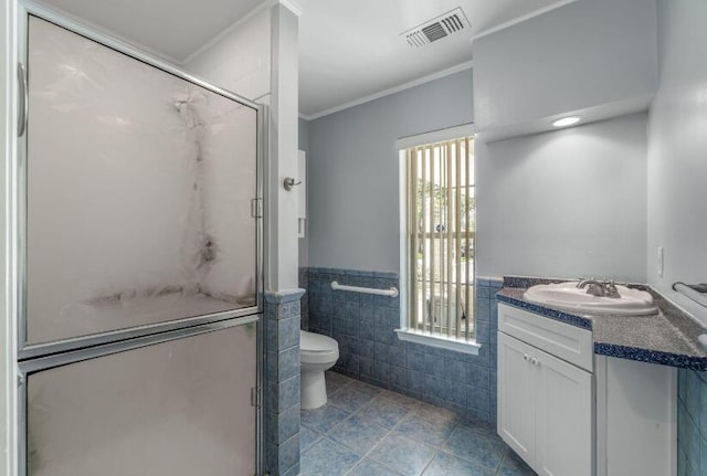 14 Winfield Way, Mary Esther, FL 32569 - bathroom featuring tile walls, vanity, tile patterned flooring, toilet, and crown molding