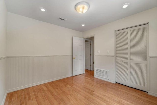 14 Winfield Way, Mary Esther, FL 32569 - unfurnished bedroom with light wood-style floors, a closet, a wainscoted wall, and baseboards
