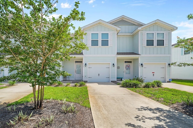 64 Crossing Ln Unit E, Santa Rosa Beach, FL 32459 - view of front of property featuring board and batten siding, driveway, and a garage