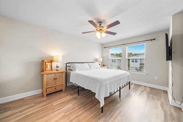 64 Crossing Ln Unit E, Santa Rosa Beach, FL 32459 - bedroom featuring light wood-style flooring, baseboards, and a ceiling fan