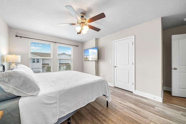 64 Crossing Ln Unit E, Santa Rosa Beach, FL 32459 - bedroom featuring baseboards, wood finished floors, and a ceiling fan