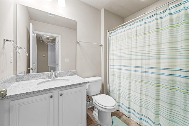 64 Crossing Ln Unit E, Santa Rosa Beach, FL 32459 - bathroom featuring vanity, toilet, wood finished floors, and a shower with shower curtain
