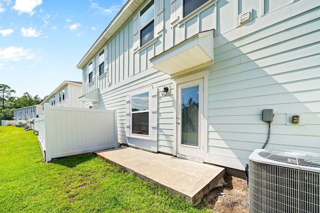 64 Crossing Ln Unit E, Santa Rosa Beach, FL 32459 - back of property featuring central AC unit and board and batten siding