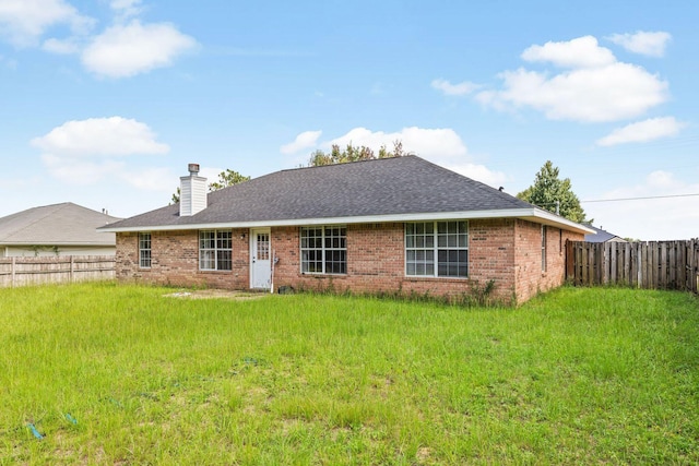 5123 Whitehurst Ln, Crestview, FL 32536 - rear view of house with a chimney, a fenced backyard, brick siding, and a shingled roof
