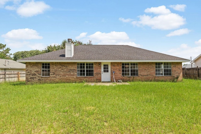 5123 Whitehurst Ln, Crestview, FL 32536 - back of house with brick siding, a chimney, and a shingled roof