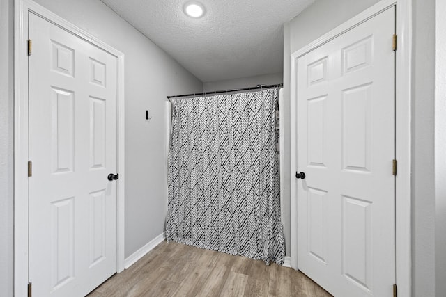 5123 Whitehurst Ln, Crestview, FL 32536 - bathroom with a textured ceiling, wood finished floors, and a shower with curtain