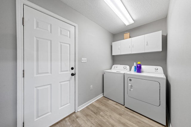 5123 Whitehurst Ln, Crestview, FL 32536 - laundry area with separate washer and dryer, cabinet space, light wood-style flooring, and a textured ceiling