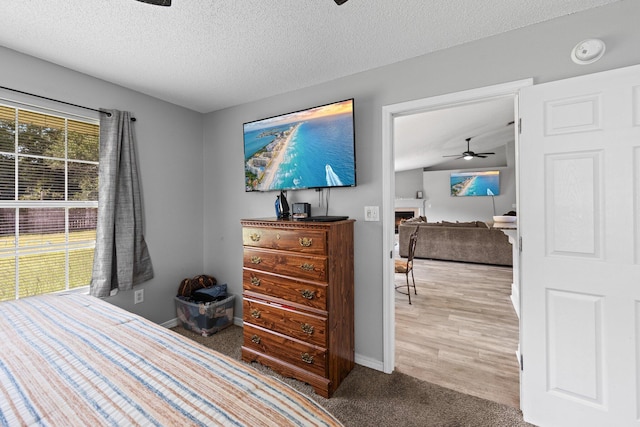 5123 Whitehurst Ln, Crestview, FL 32536 - bedroom with a textured ceiling, a warm lit fireplace, and carpet