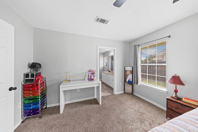 5123 Whitehurst Ln, Crestview, FL 32536 - bedroom with carpet floors, a textured ceiling, ceiling fan, and ensuite bath