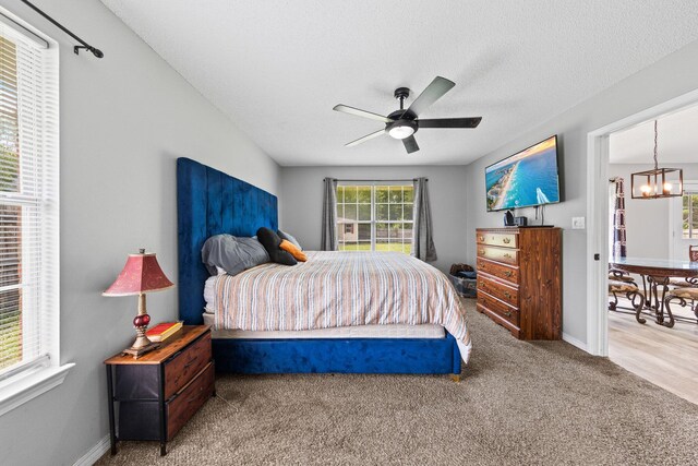 5123 Whitehurst Ln, Crestview, FL 32536 - bedroom featuring a chandelier, carpet floors, a ceiling fan, and a textured ceiling