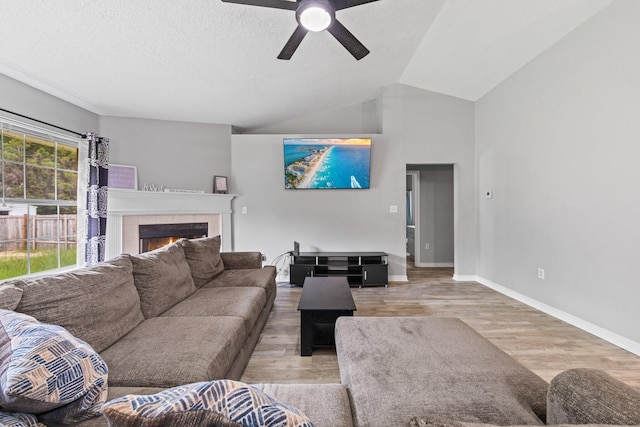 5123 Whitehurst Ln, Crestview, FL 32536 - living area featuring wood finished floors, a tile fireplace, ceiling fan, and lofted ceiling