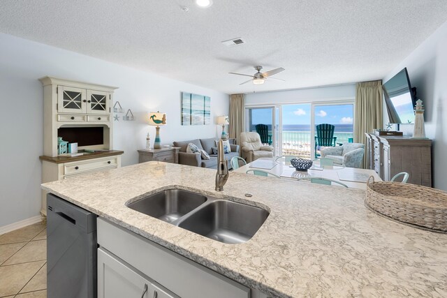 2606 Scenic Gulf Dr Unit 2412, Miramar Beach, FL 32550 - kitchen featuring a sink, dishwasher, open floor plan, ceiling fan, and a textured ceiling