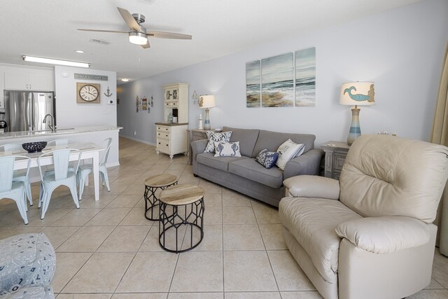 2606 Scenic Gulf Dr Unit 2412, Miramar Beach, FL 32550 - living area featuring ceiling fan, light tile patterned floors, and baseboards